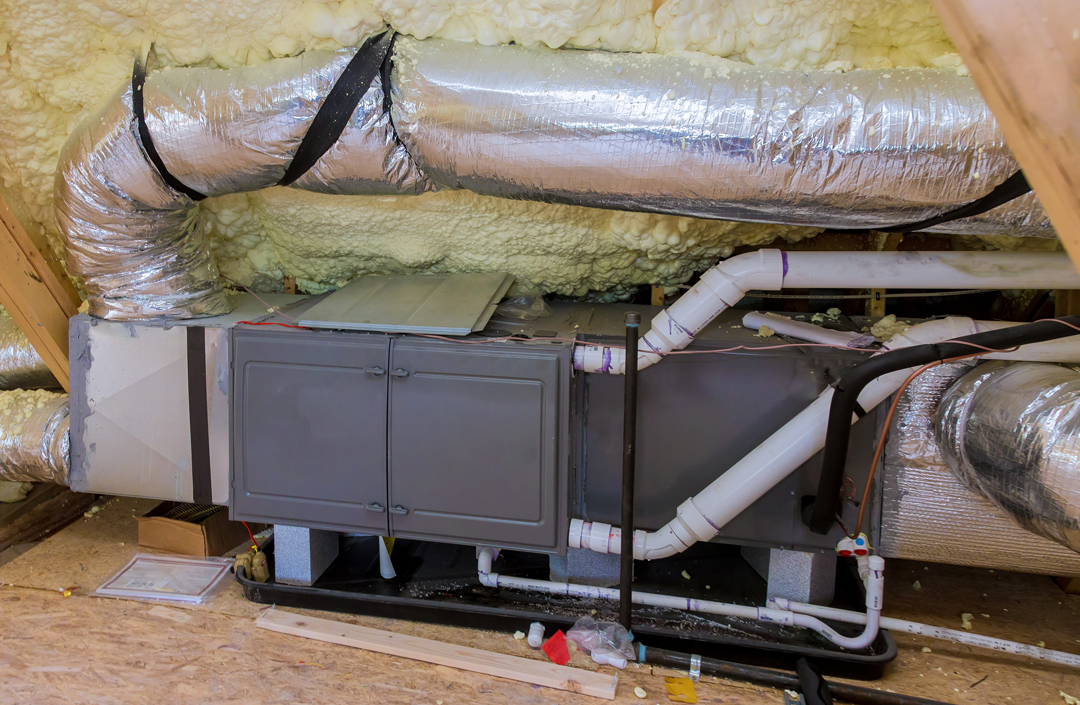 HVAC system in attic with mess around it