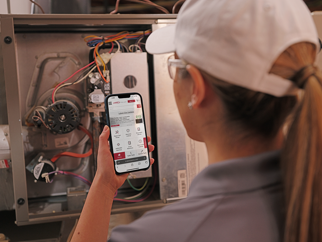 heating-maintenance Lennox heating system maintenance tech using app