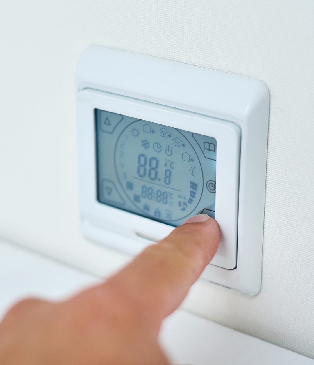 Men hand setting temperature on the underfloor heating control p This proactive approach optimizes comfort while minimizing energy consumption during weather transitions. Zoning system compatibility allows advanced thermostats to control multiple heating and cooling zones independently, providing customized comfort for different areas of larger homes. This capability works well for multi-level homes throughout Marion and Herrin where sun exposure and usage patterns create different temperature needs between zones. Emergency heat controls provide manual override capabilities for heat pump systems during equipment problems or extreme cold weather that requires backup heating activation. Proper emergency heat operation protects equipment while maintaining heating capability when primary systems need service attention.